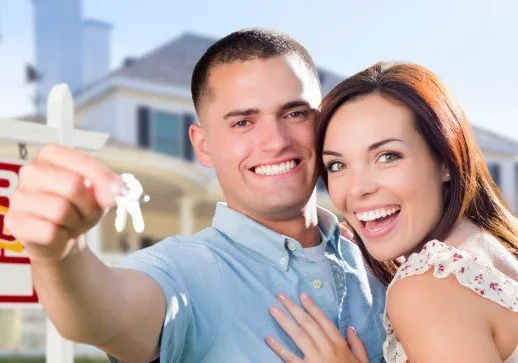 Couple holding the keys to a house