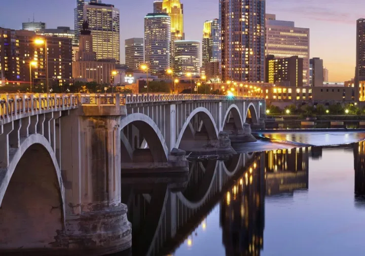 Minneapolis skyline and river bridge at dusk